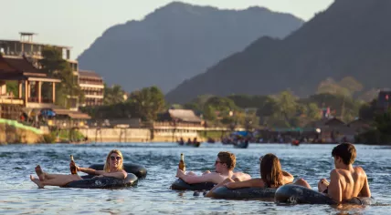 Tourists enjoying tubing in Song River in Vang Vieng, Laos