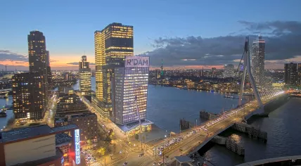 Clouds pass over Rotterdam at Dusk as traffic builds on the Erasmus Bridge. 26 November 2024.