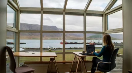 A woman working remotely from a location in Iceland