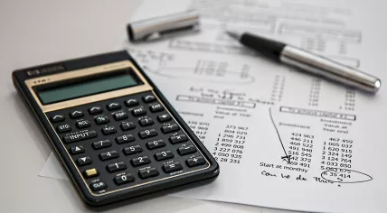 A calculator along with investment and finance projections
