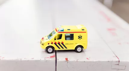 A toy ambulance with a similar color scheme as those used in the Netherlands