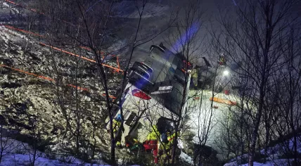 Members of the emergency services work after a bus went off the road on the E10 and plunged into a lake in Hadsel, Nordland, Norway, 26 December 2024. At least three people have died and four are seriously injured, according to police. 