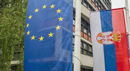 Serbian and EU flags hanging on poles