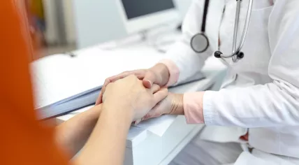 A doctor is comforting her patient