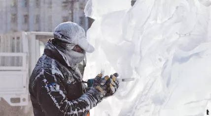 A man carves an ice sculpture