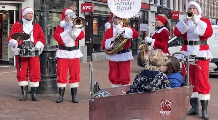 The Winter Wonder Band dressed up in Santa suits on the Dappermarkt in Amsterdam. 20 December 2024