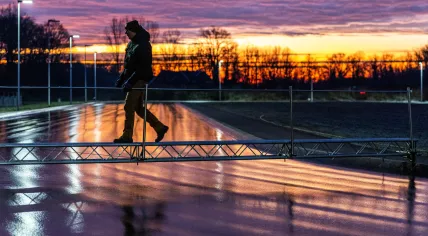 An ice master inspects the newly formed ice surface from a footbridge. The sprayed ice rink at the Winterswijkse IJsvereniging is among the first to open for skating after just a few nights of frost. 14 Jan. 2026