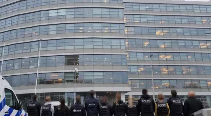 German police officers in front of an Amsterdam police station after conducting raids as a result of Dutch criminal's violence in Germany