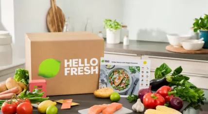 A HelloFresh box with ingredients for their grilled salmon recipe with vegetables and couscous. 2023