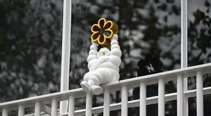 The Michelin Man holding a star above Coulisse after the Amsterdam restaurant secured the award in 2023.