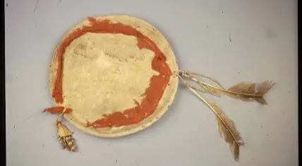 A Tigua shield made from wood, hide, cloth and feathers by the Ysleta del Sur Pueblo Native American tribe in the 19th century