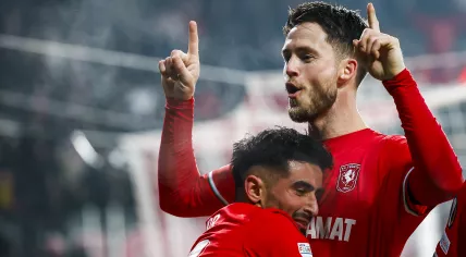 Naci Unuvar of FC Twente, Ricky van Wolfswinkel of FC Twente celebrate the 2-1 during the Europa League play-off match between FC Twente and Bodo/Glimt at Stadion De Grolsch Veste on February 13, 2025 in Enschede, Netherlands.
