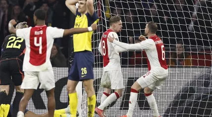 Ross Sykes of Royale Union Saint-Gilloise is disappointed, Kenneth Taylor of Ajax, Jordan Henderson of Ajax celebrate during the Europa League play-off match between Ajax Amsterdam and Union SG at the Johan Cruijff ArenA on February 20, 2025 in Amsterdam, Netherlands.