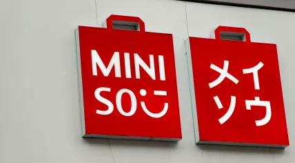 The logo for discount retail chain Miniso above a store front