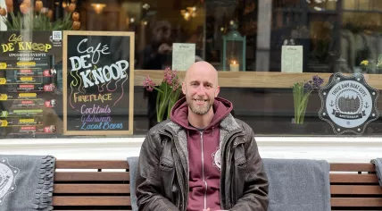 Neil Robinson sits outside Cafe de Knoop