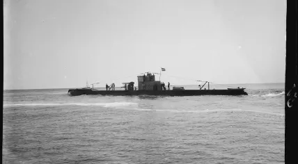 Submarine Hr. Ms. K XI passing Den Helder with crew members on deck in 1930