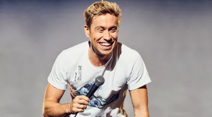 Russell Howard performing comedy on stage 