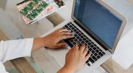 Someone typing a message on an Apple MacBook Air laptop in 2020