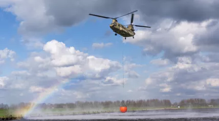 A Dutch military Chinook helicopter collecting thousands of liters of water in a Bambi Bucket during a drill in Amersfoort. 19 March 2024