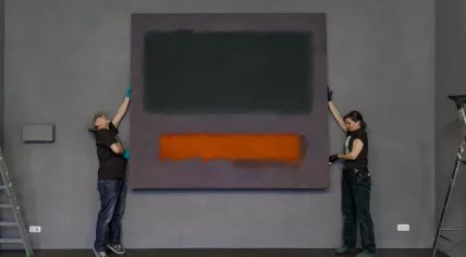 Art handlers from Museum Boijmans Van Beuningen install Mark Rothko’s Grey, Orange on Maroon, No. 8 (1960) at the Stedelijk Museum Schiedam.