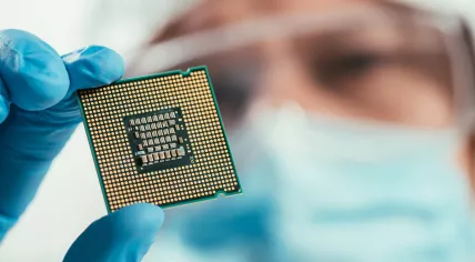 Engineer holds a microchip.