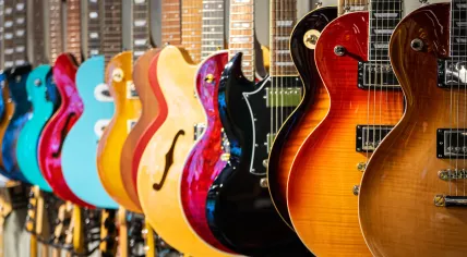 A row of acoustic and electric guitars.