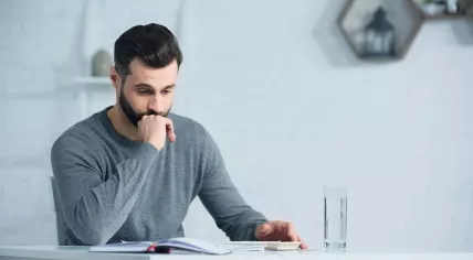 A worried man is doing taxes