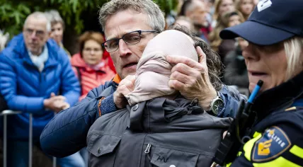Police remove pro-Palestinian activists at the start of the National Liberation Day Celebration in Wageningen, Netherlands, Sunday, May 5, 2025.