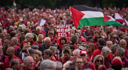 Protesters dressed in red march through The Hague to draw a symbolic "red line" against the Dutch cabinet’s stance on Israel. Organizers estimated the crowd exceeded 100,000, calling it the largest demonstration in the Netherlands in 20 years, May 18, 2025.