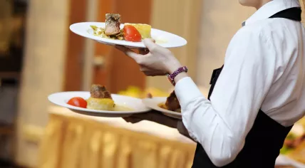 A waitress carrying plates.