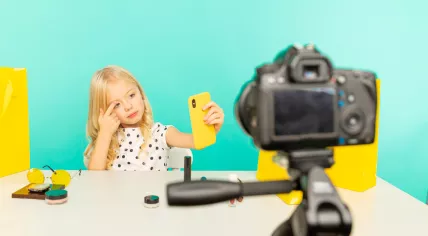 Girl speaking in front of camera for a vlog.