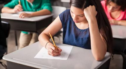 Secondary school students writing an exam