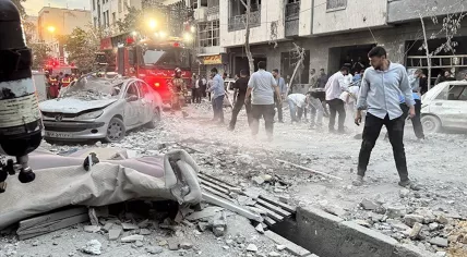 The aftermath of an Israeli airstrike was visible in one Tehran neighborhood, where firefighters and residents navigated the rubble. 13 June 2025