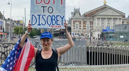 Demonstrators carry banners at ‘No Tyrants’ rally in Amsterdam against Trump’s ‘authoritarian overreach’.