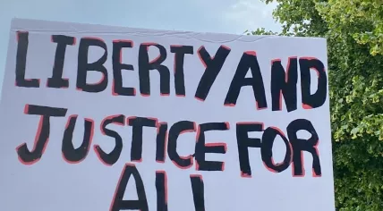 Demonstrators carry banners at ‘No Tyrants’ rally in Amsterdam against Trump’s ‘authoritarian overreach’.