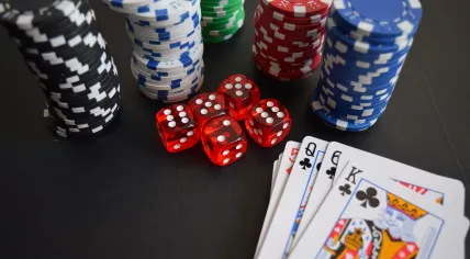 Playing cards, dice, and casino chips on a tabletop