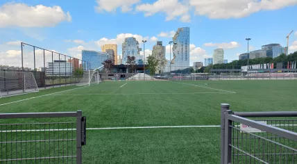 Artificial football pitch belonging to amateur club AFC with the Amsterdam Zuidas in the background.