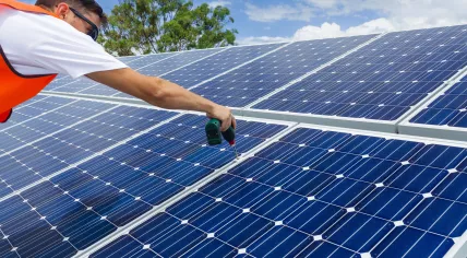Worker is installing solar panels