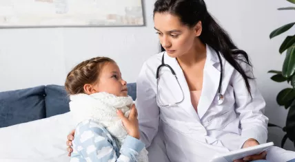 A doctor is treating a sick child at home.