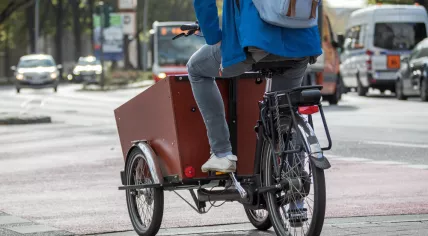 Man with backpack on a cargo bike