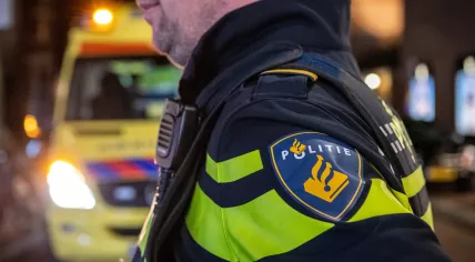 A police officer with an ambulance in the background