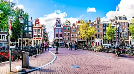 Tourist taking a photo at the bridge over the Singelgracht at the Weide Heisteeg in the historic center of Amsterdam