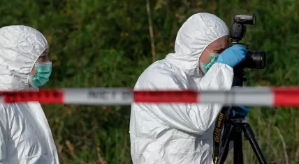 Dutch police: Forensic investigators standing behind crime scene tape