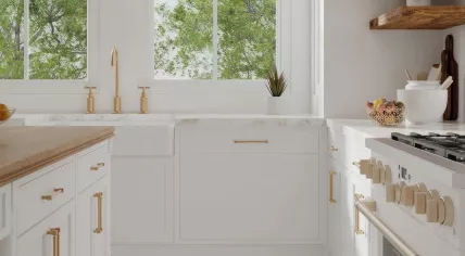A white kitchen interior with, marble, brass, and wood countertops and features. 27 Dec. 2024