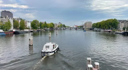 Looking north on the Amstel River from Nieuwe Amstelbrug on a hot day in Amsterdam.  12 Aug 2025
