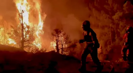 Emergency workers try to tackle wildfires north of Madrid, Spain. 12 August 2025
