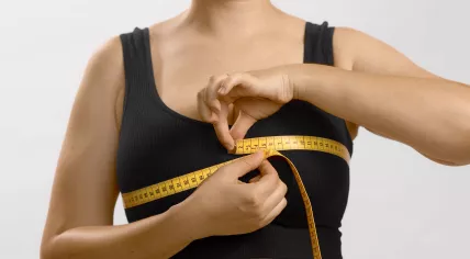 Measuring chest with tape.
