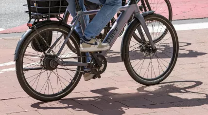 A person is riding an electric bicycle