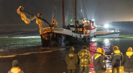 People await the sailing charter Storebaelt at the Harlingen port after it collided with a freighter on the Wadden Sea with 25 German school children on board, 14 September 2025