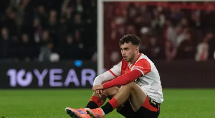 Feyenoord's Aymen Sliti sits on the pitch at the end of the Europa League opening phase soccer match between Feyenoord and Aston Villa at the Feyenoord "De Kuip" stadium in Rotterdam, Netherlands, Thursday, Oct. 2, 2025.